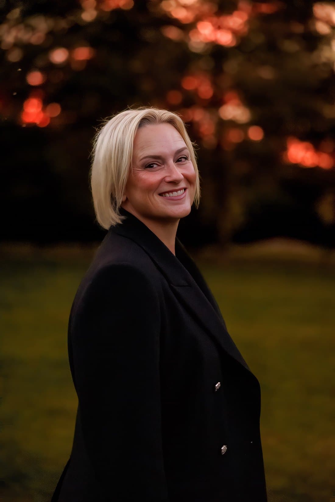 Karen Dade smiling outdoors at sunset